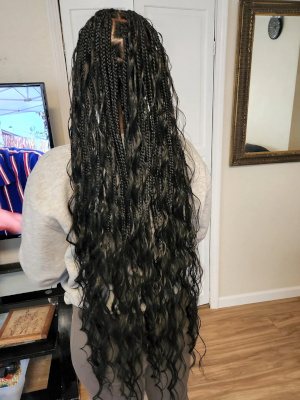 Very long black braids with wavy loose ends, back view.