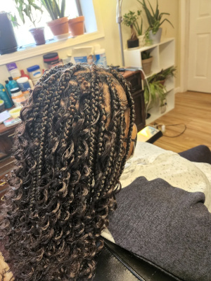Half-up braided style with loose curls.