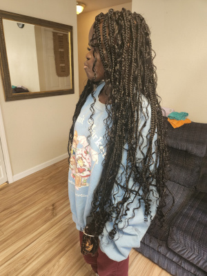 Long box braids with loose curly ends, side view