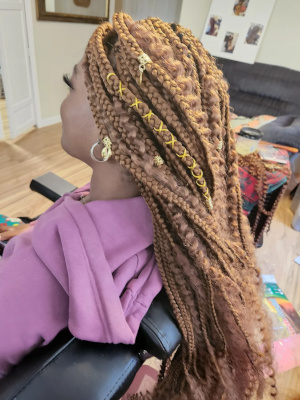 Copper-colored braids with gold accessories.